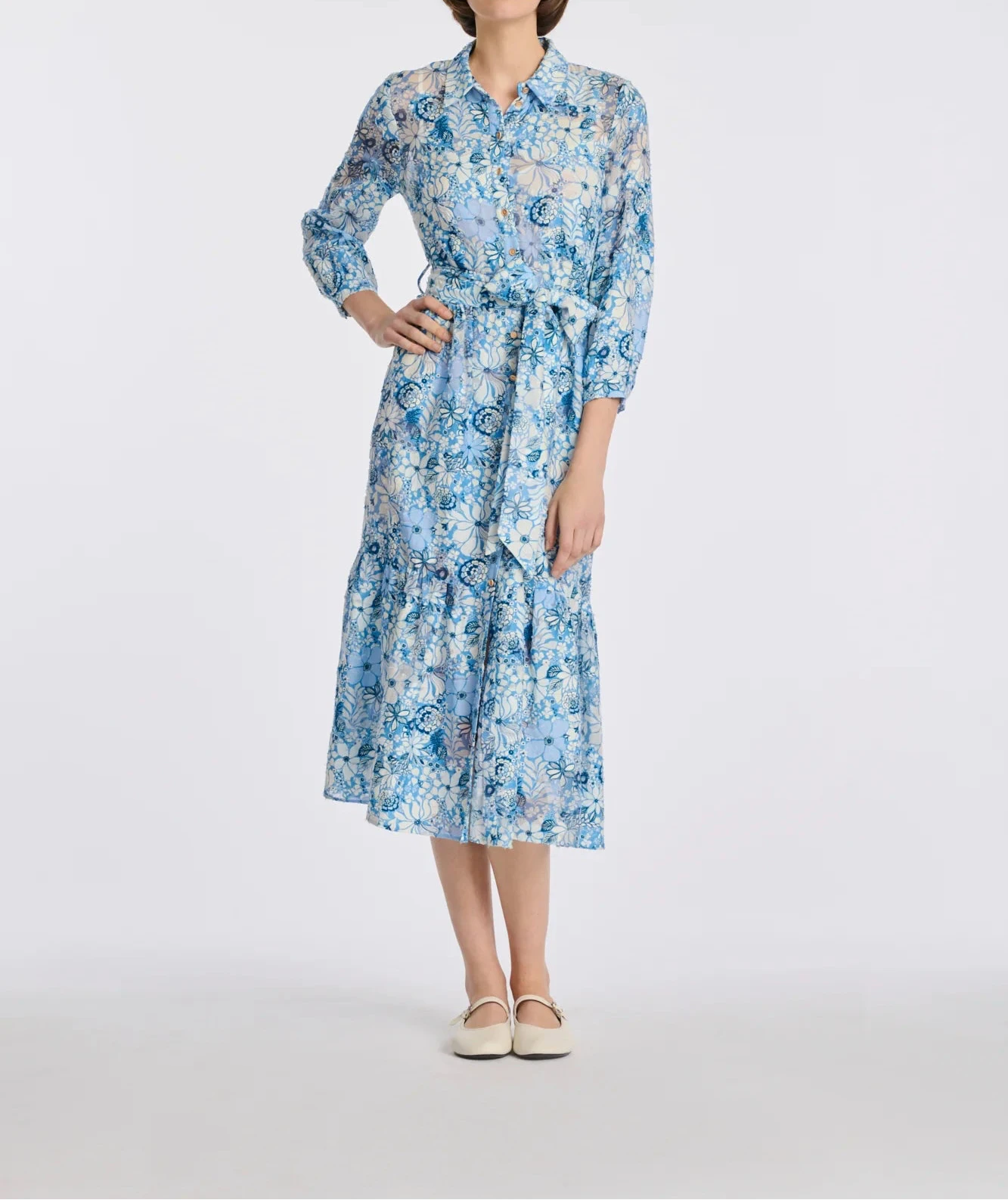 Full-length front view of blue floral silk and cotton midi shirt dress with belt on model