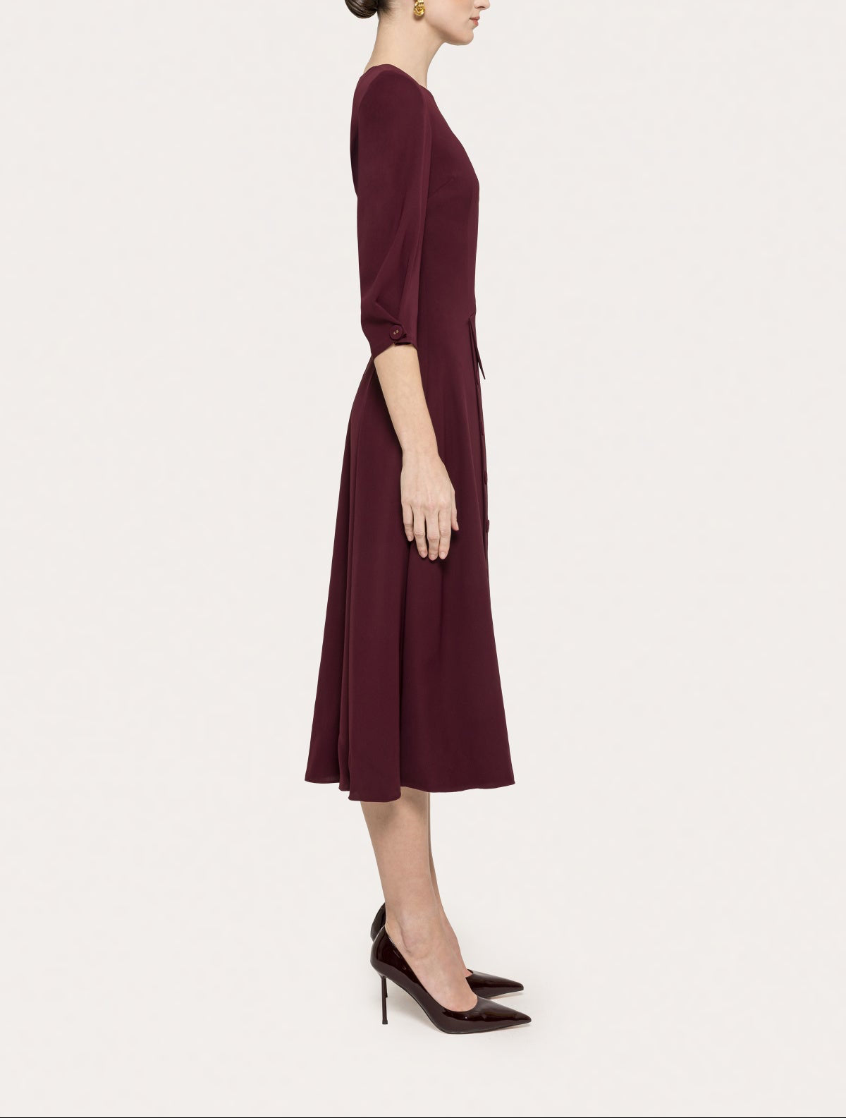 Side view of NISSA bordeaux midi dress with high round neckline, 3/4 sleeves and flared hem