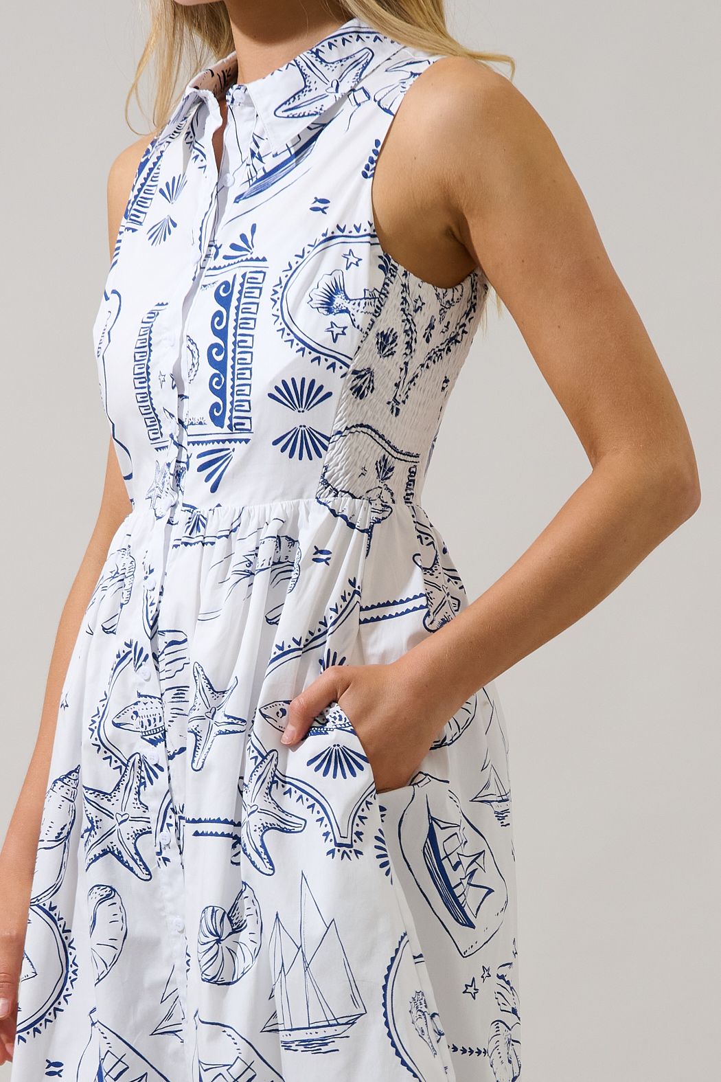 Close-up of collared button-front bodice and side pocket on blue and white seaside print midi dress