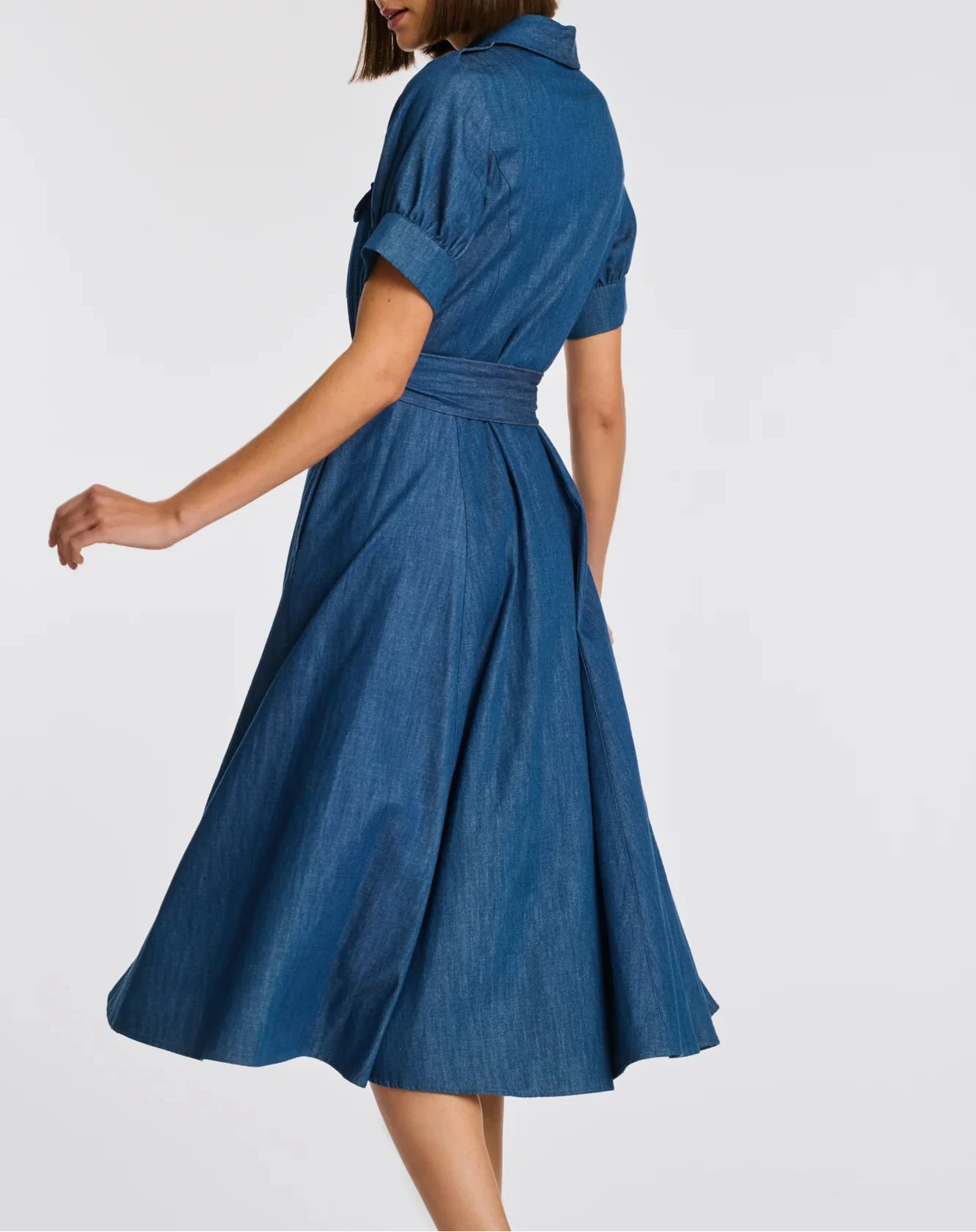 Side view blue denim belted midi shirt dress with cuffed short sleeves