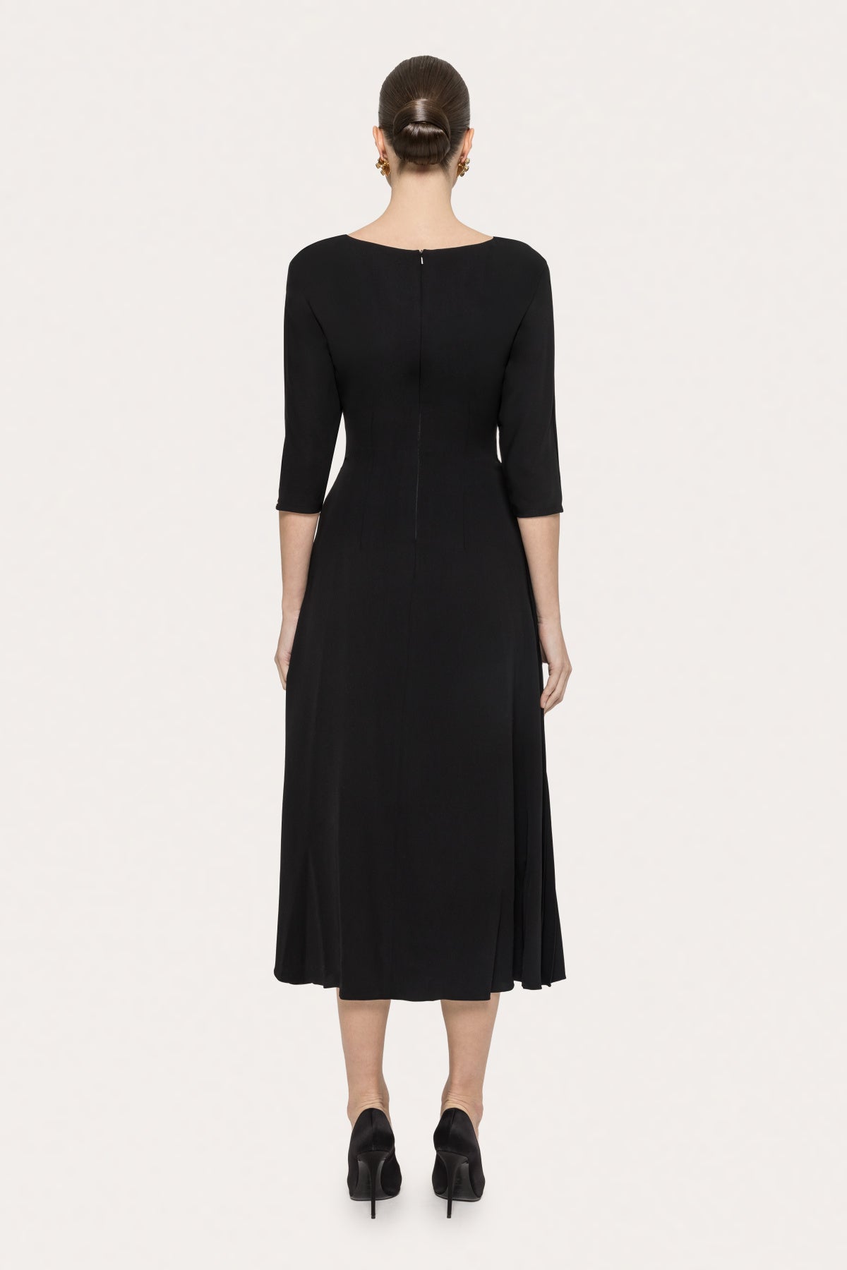 Back view of NISSA black midi dress with boat neckline and center back zipper