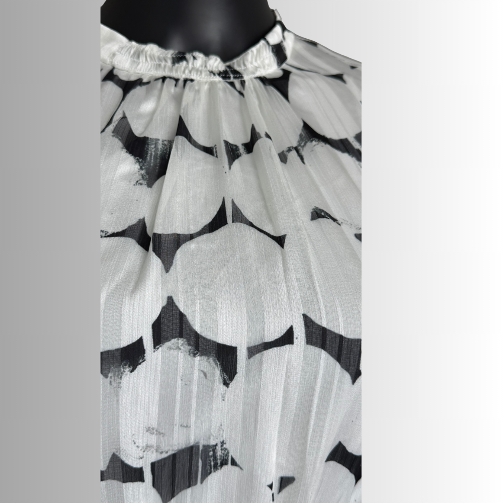 Close-up of gathered neckline on black and white abstract print chiffon dress by Nora Noh