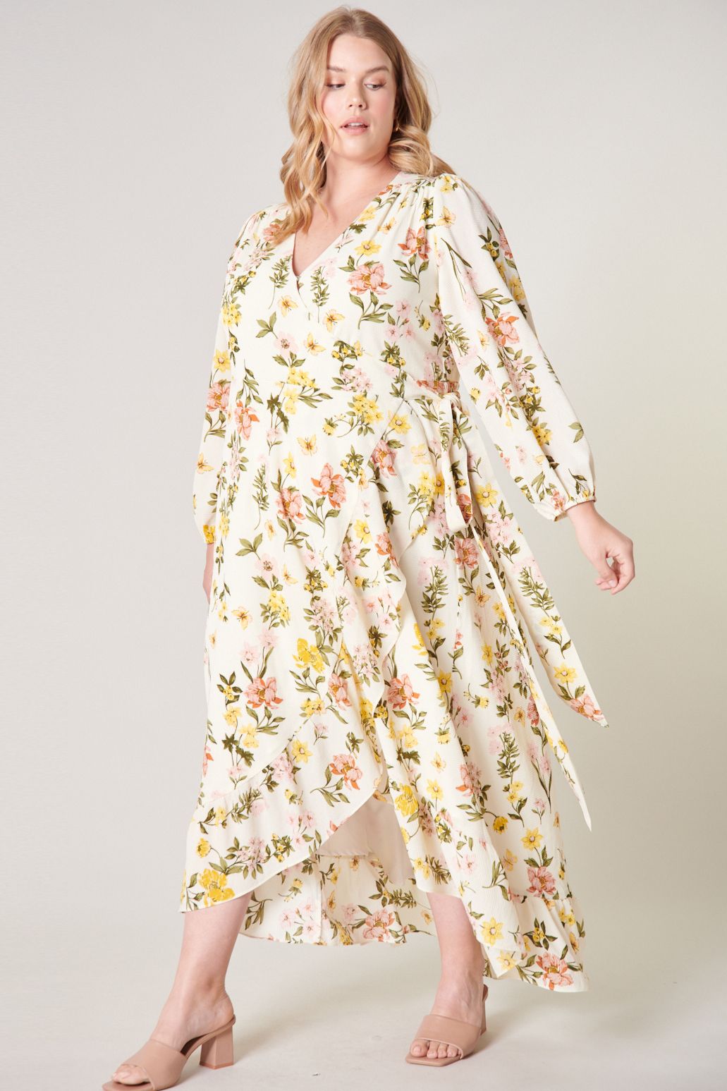 Plus size ivory floral wrap maxi dress with self-tie waist and flowing ruffle hem