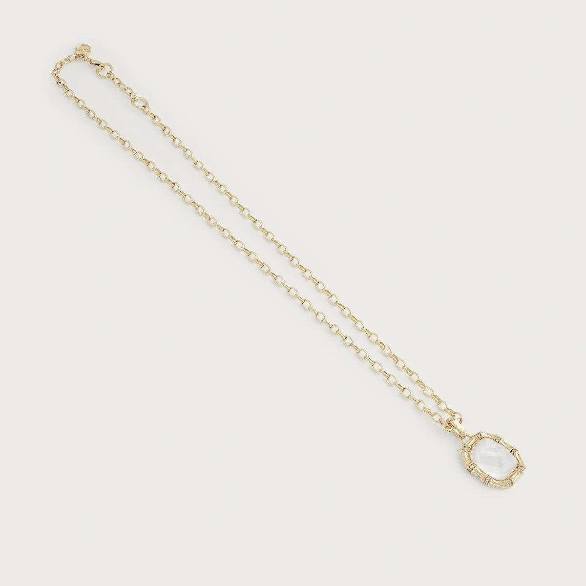 Bamboo with Stone Pendant Necklace by Anabel Aram featuring a faceted mother‑of‑pearl stone framed by gold bamboo segments with pavé crystal accents on an adjustable gold chain.