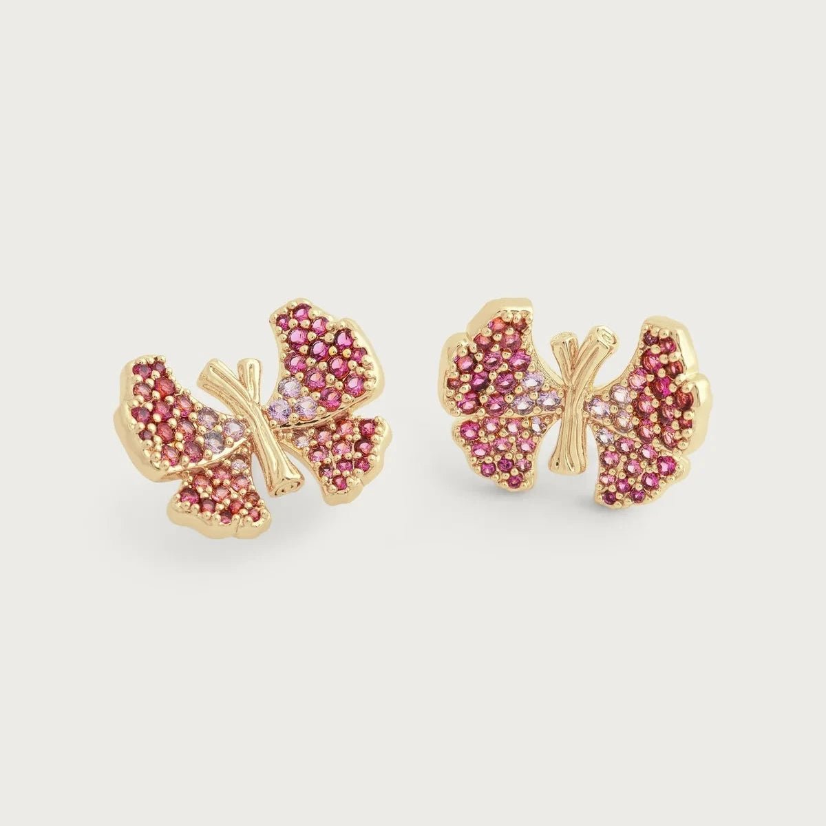 Anabel Aram Butterfly Pink Pavé Stud Earrings featuring petite butterflies crafted from gold‑plated brass and fully encrusted with shimmering pink pavé crystals.