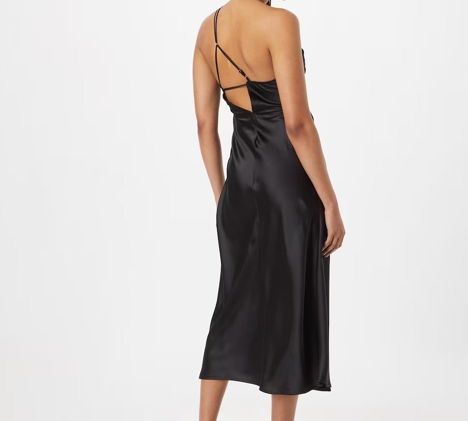 Black satin one-shoulder midi dress with draped waist detail for wedding guest and evening events