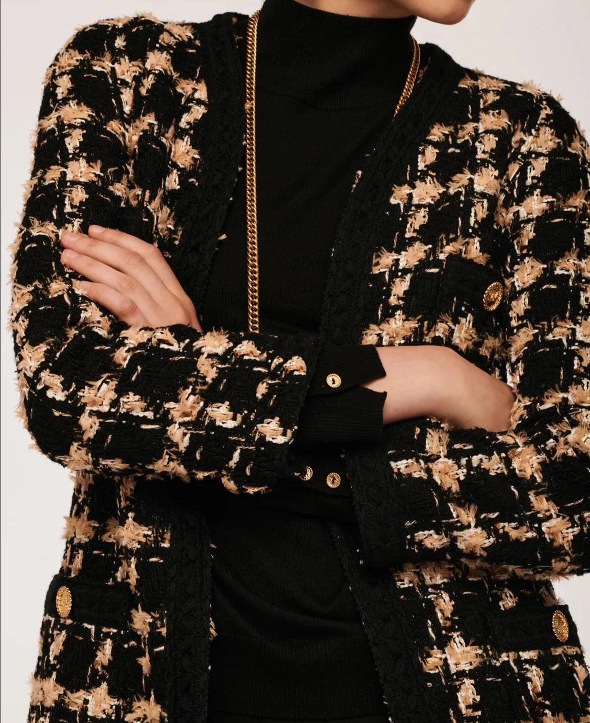 Close-up of longline black and beige check tweed jacket with braid trim and gold-tone buttons by Weill Paris