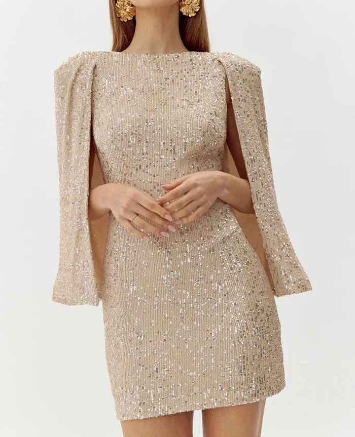 Close-up of champagne sequins and cape sleeve detail on mini evening dress