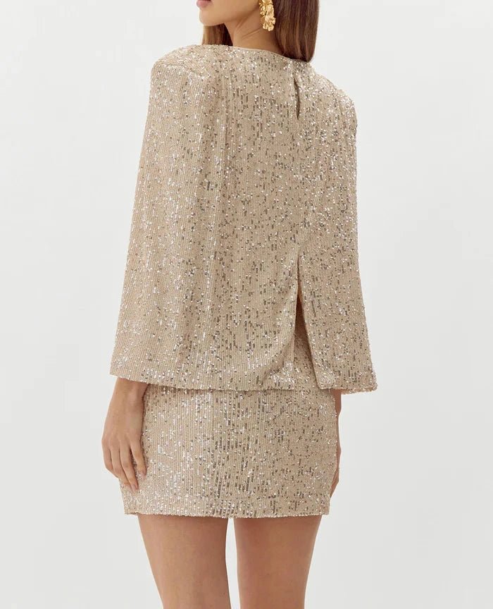 Champagne sequin mini dress with cape sleeves and fitted silhouette back view