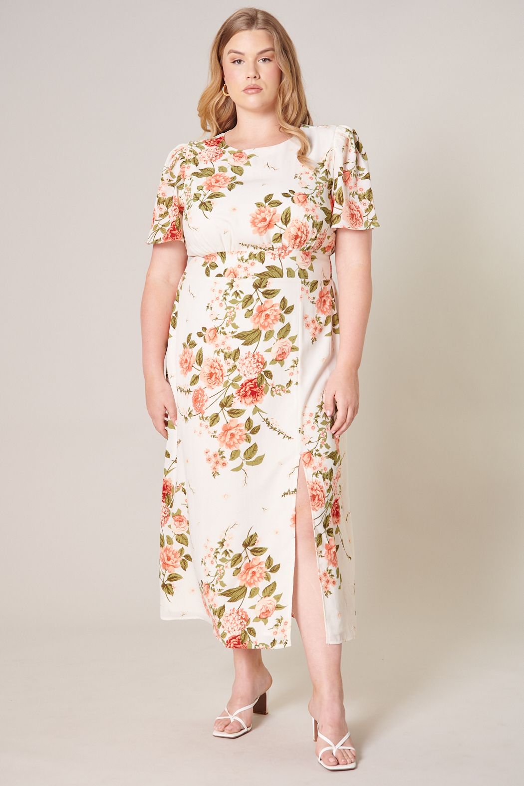 Plus size ivory floral midi dress with flutter sleeves and front slit front view