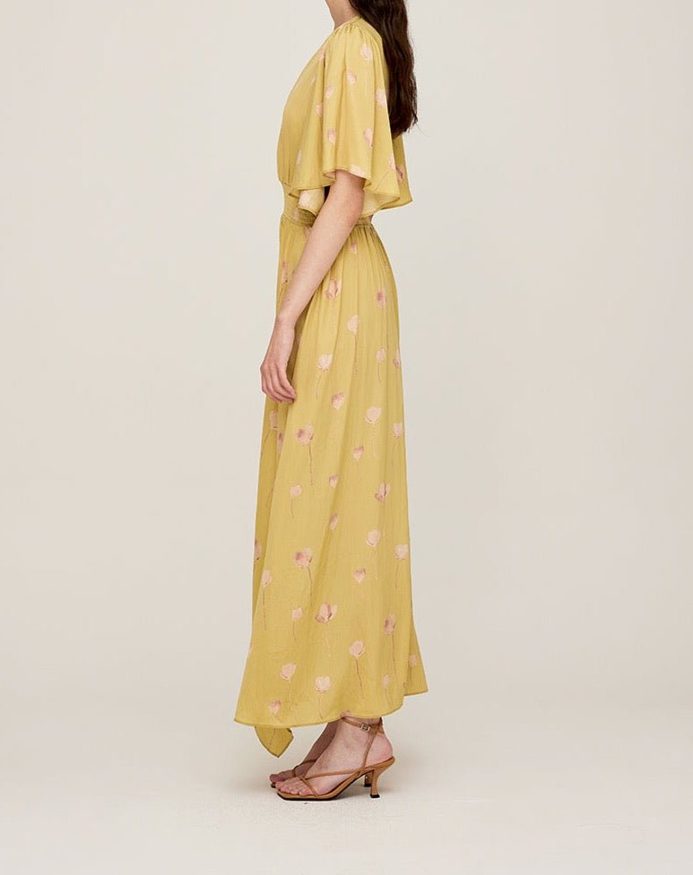 Side view of butter yellow maxi dress with flowing silhouette