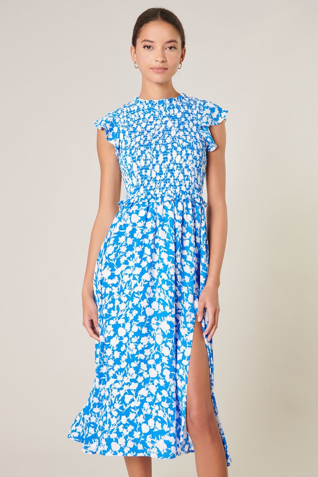 Blue and white smocked midi dress with ruffle cap sleeves front view
