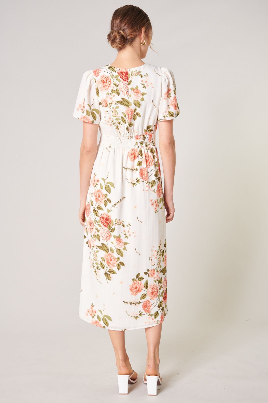 Back view of ivory floral midi dress with keyhole back and smocked waistband