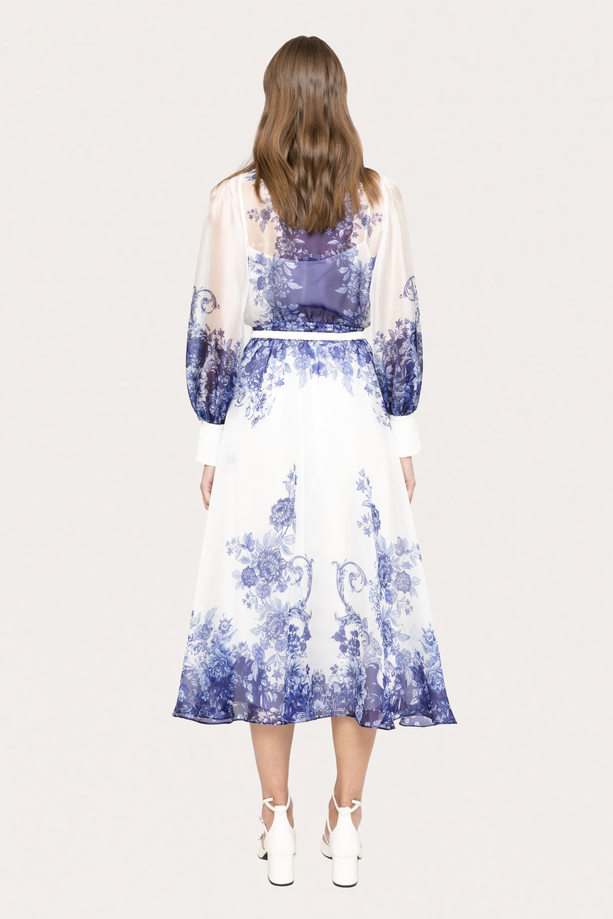 back side of blue and white floral organza dress with button front and collar neckline