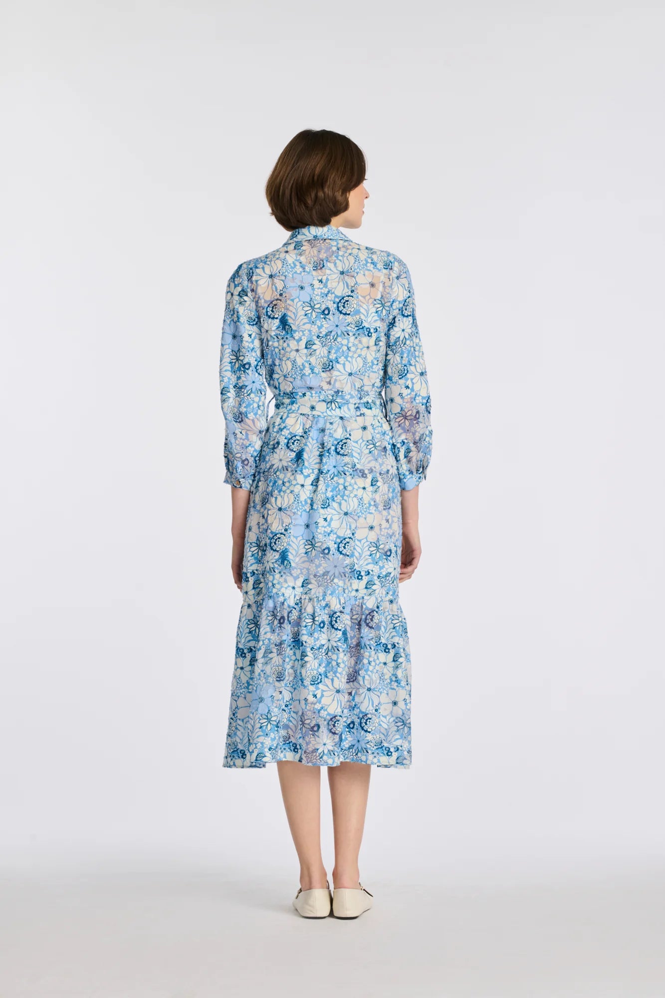 Full back view of blue floral silk and cotton shirt dress on model