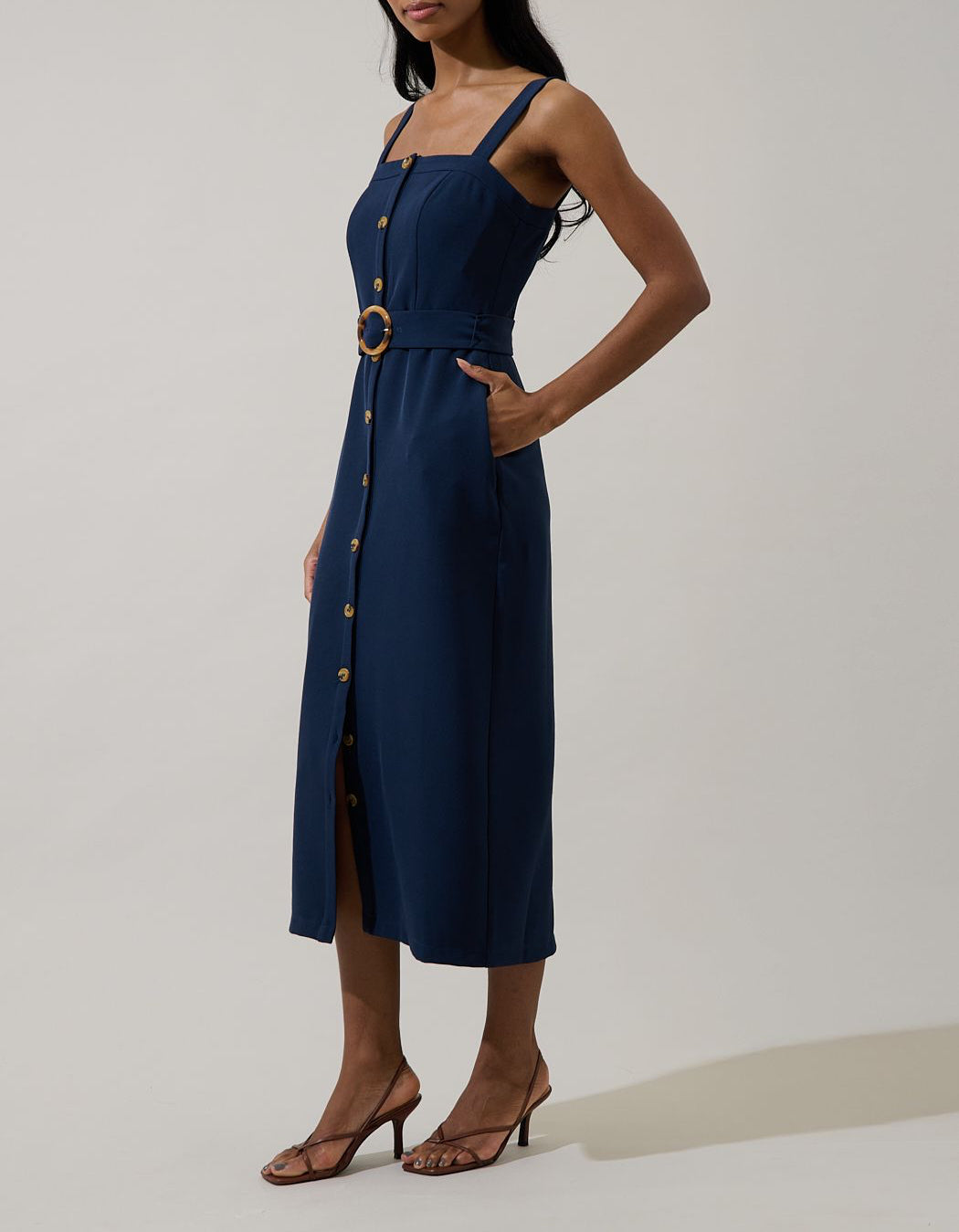 Side view of dark navy belted square neck midi dress with pockets