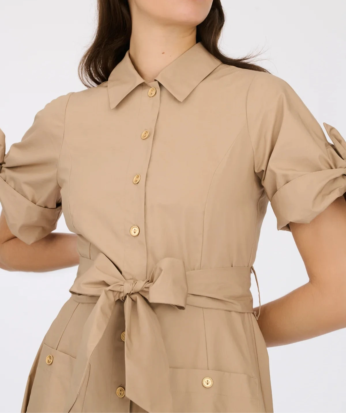 Detail of beige belted midi shirt dress with patch pockets and short tie sleeves