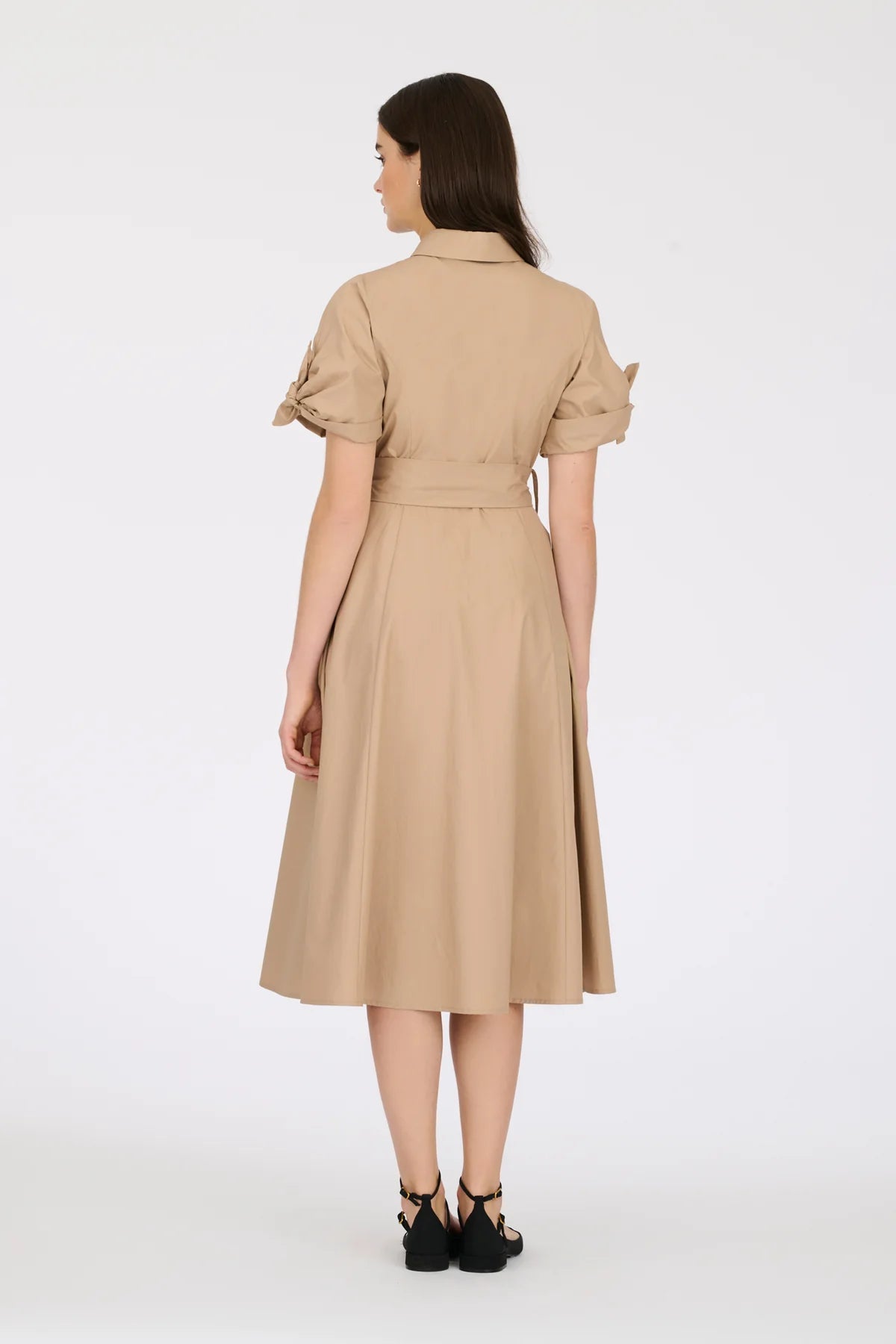 Back view of beige cotton midi shirt dress with belted waist and short tie sleeves on model