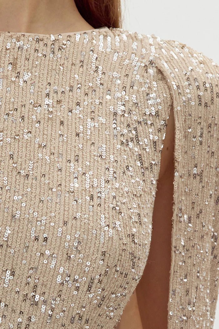 Champagne sequin bodycon mini dress with draped cape sleeve detail side view