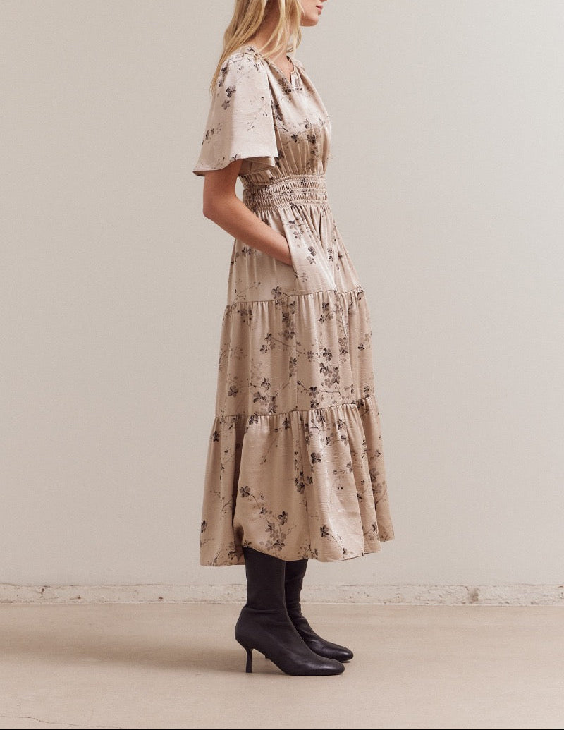 Side view of natural floral midi dress with smocked waist and pockets