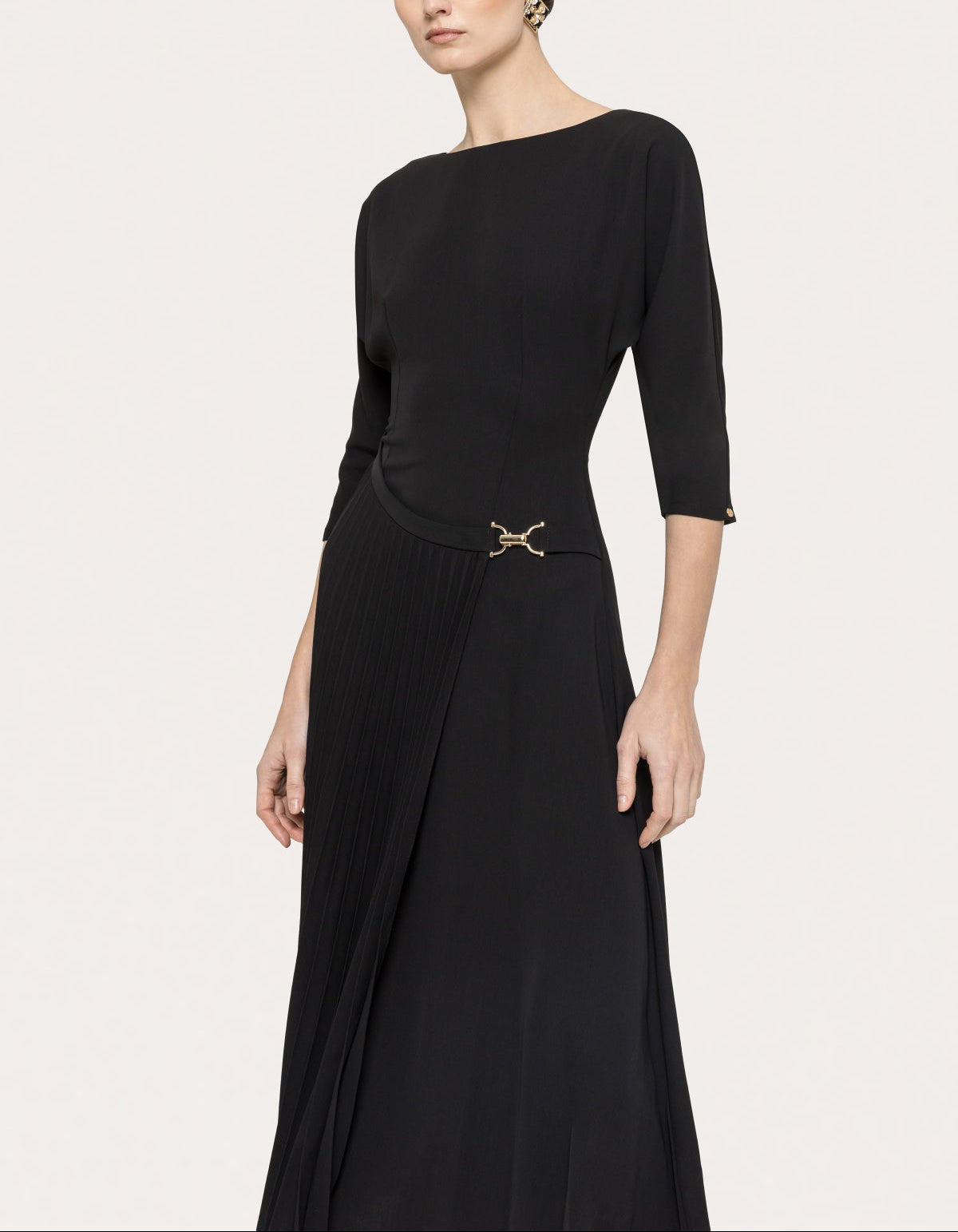 Elegant black midi dress with three-quarter sleeves, defined waist, and pleated skirt panel