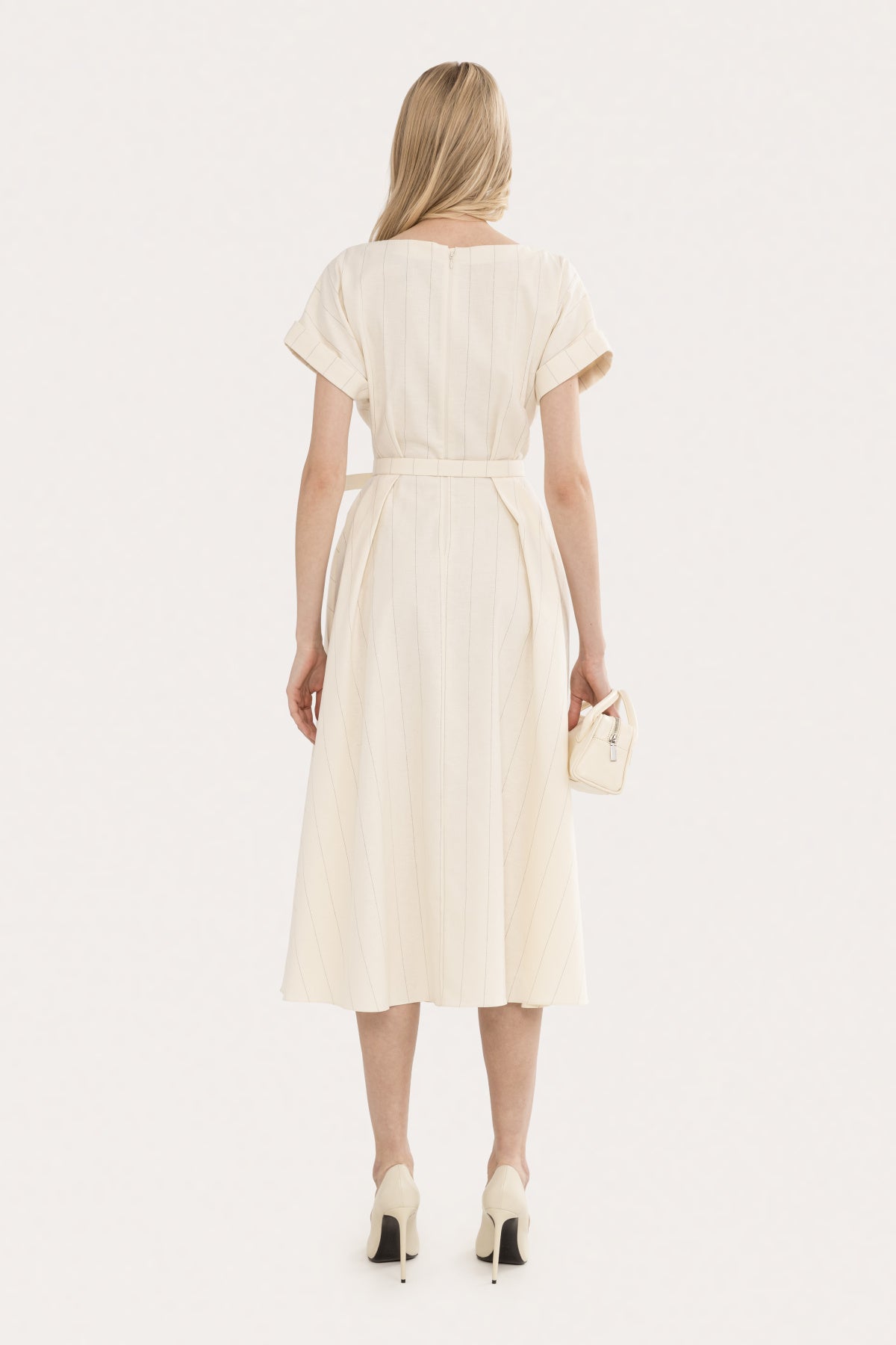 Back view of an ivory pinstripe midi dress with short sleeves, defined waist, and A-line silhouette
