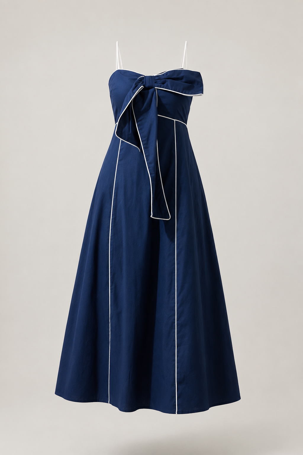 Front product view of the Viona navy midi dress with white piping, oversized bow, sweetheart neckline and slim contrast straps.