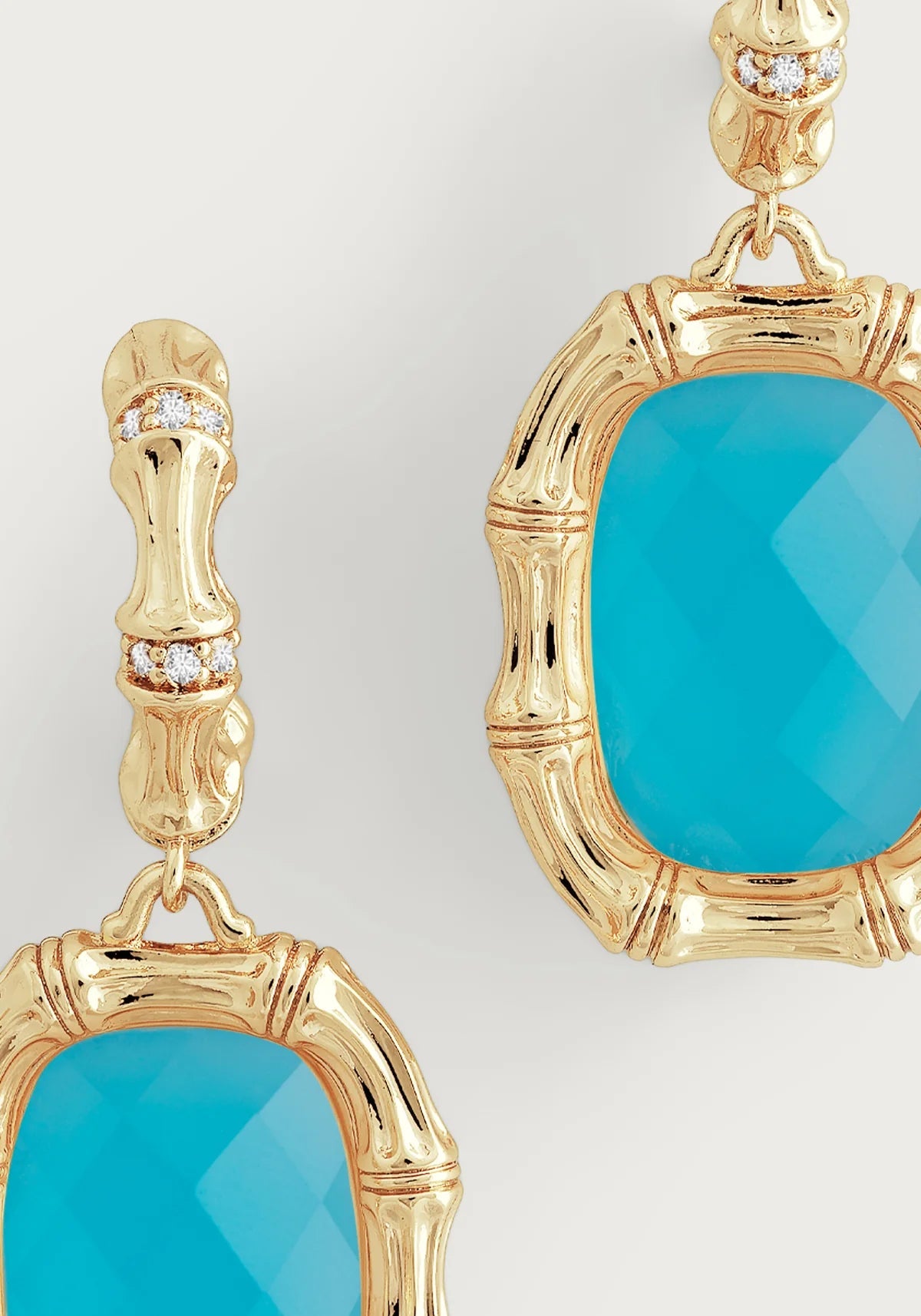 Woman wearing gold bamboo statement earrings