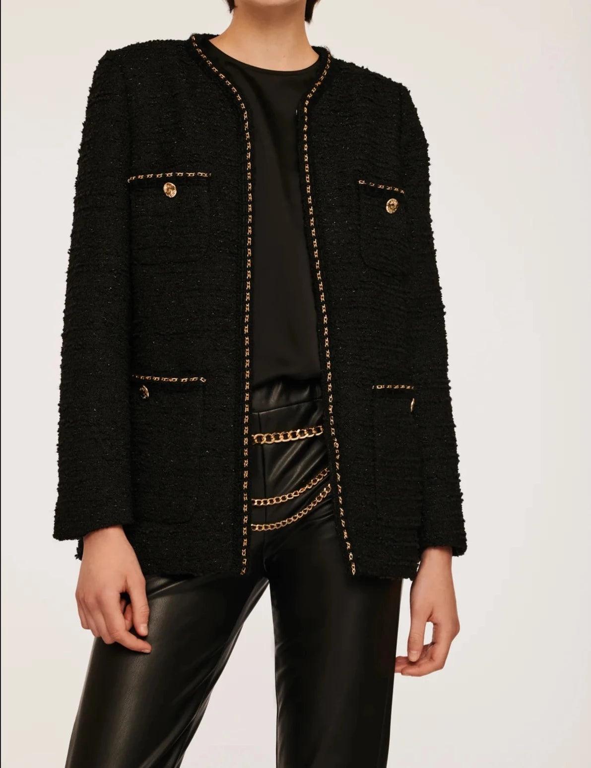 Black collarless tweed jacket with gold chain trim and decorative buttons by Weill Paris, front close view
