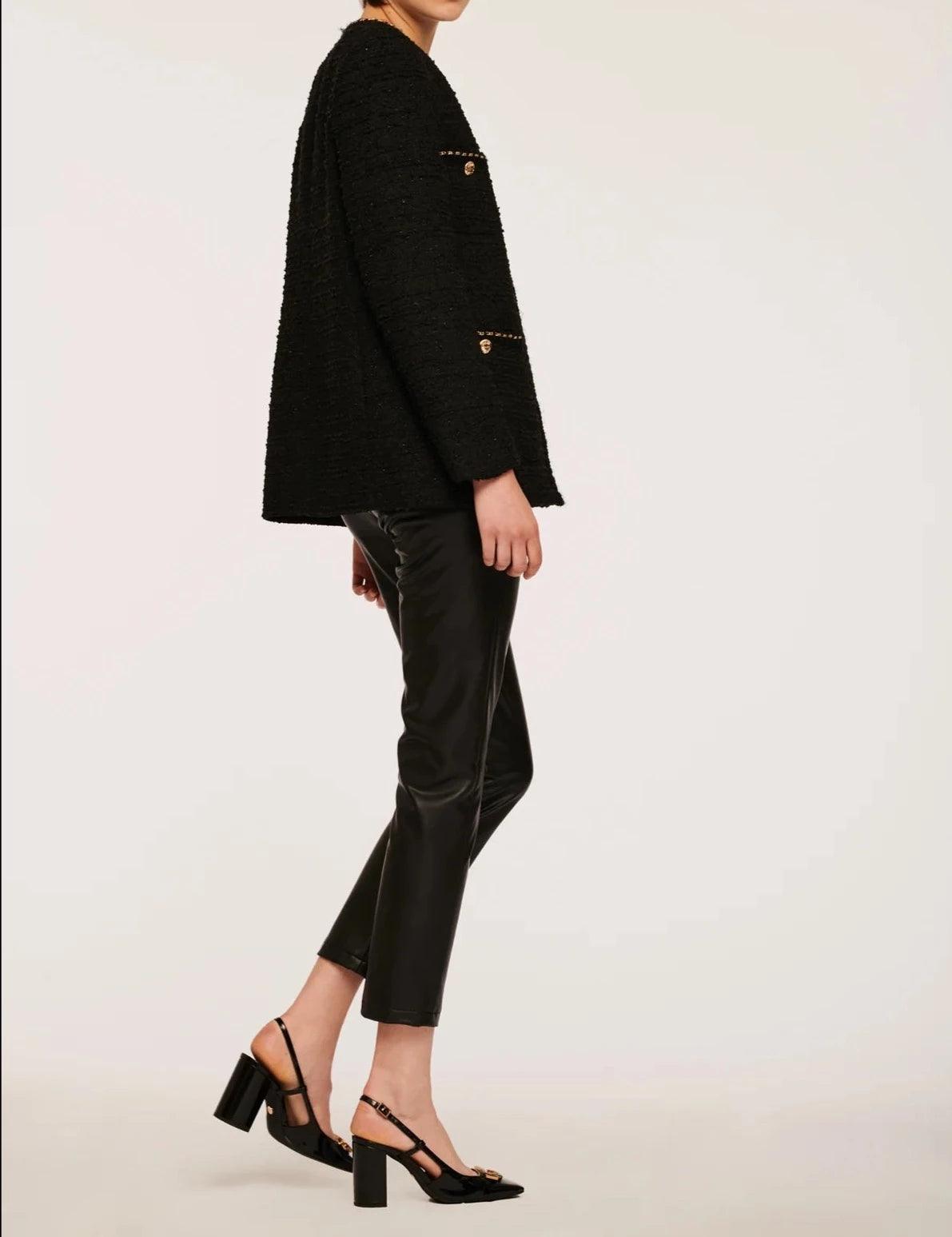 Side view of black collarless tweed jacket with gold trim for women by Weill Paris