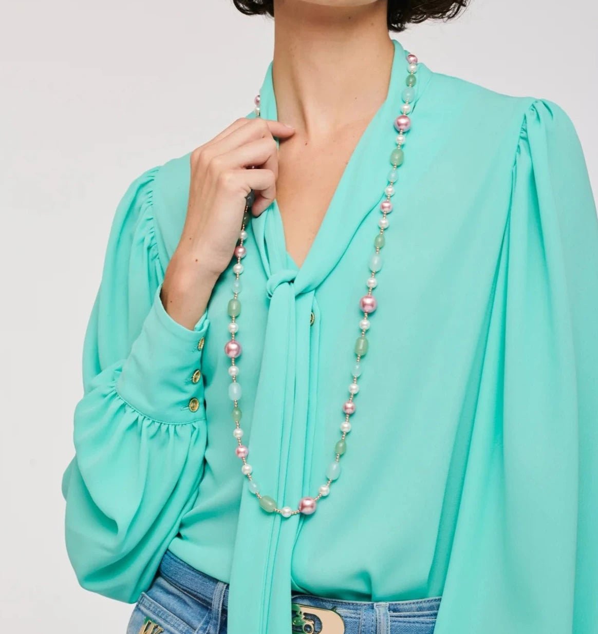 Weill Paris multicolor pearl bead long necklace in pastel mint and blush tones styled with an aqua bow blouse and denim jeans