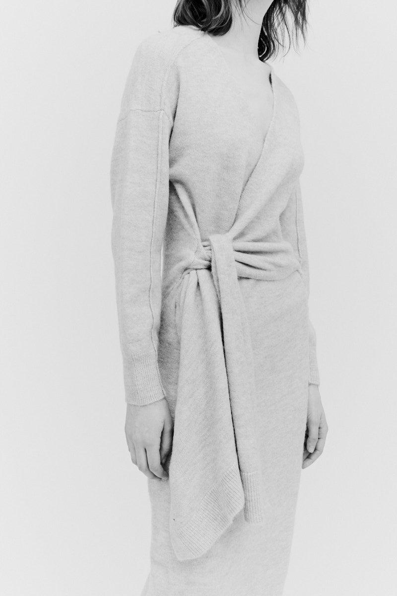 Close-up of side tie detail on oat knit sweater dress with soft stretch fabric