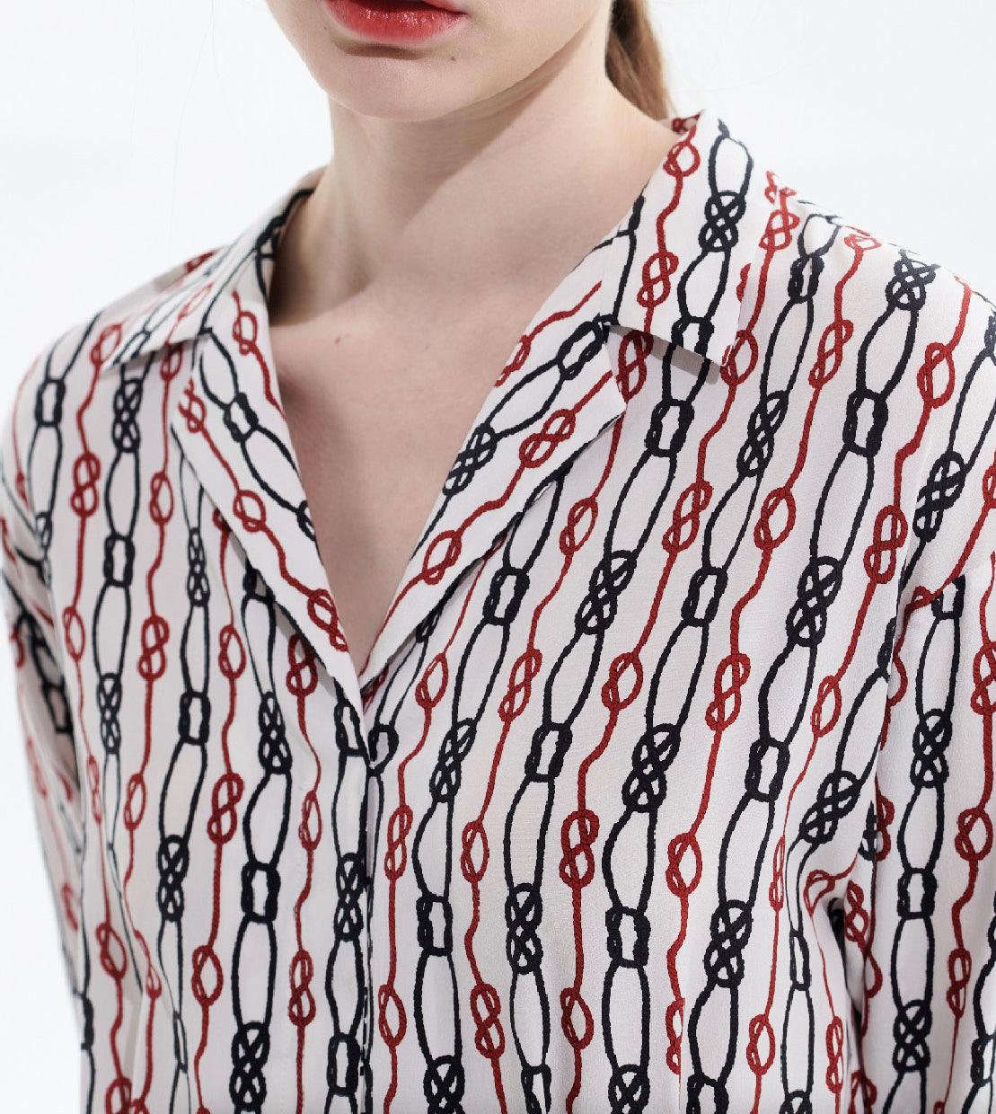 Close-up of chain print pattern on silk midi dress