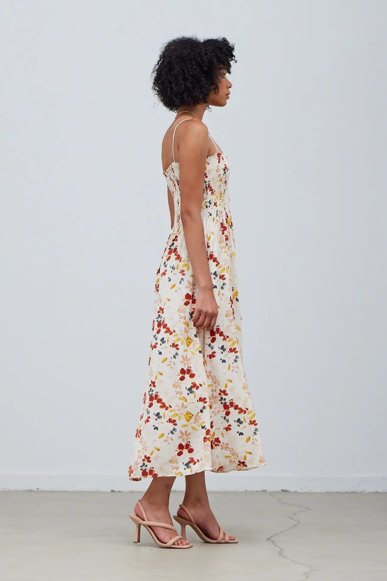 Side view of Grade & Gather cream floral satin midi dress with flowy A-line skirt and spaghetti straps