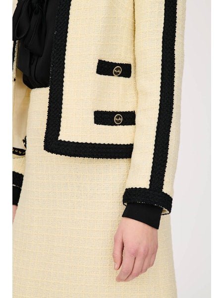 Parisian ecru tweed jacket styled with matching skirt