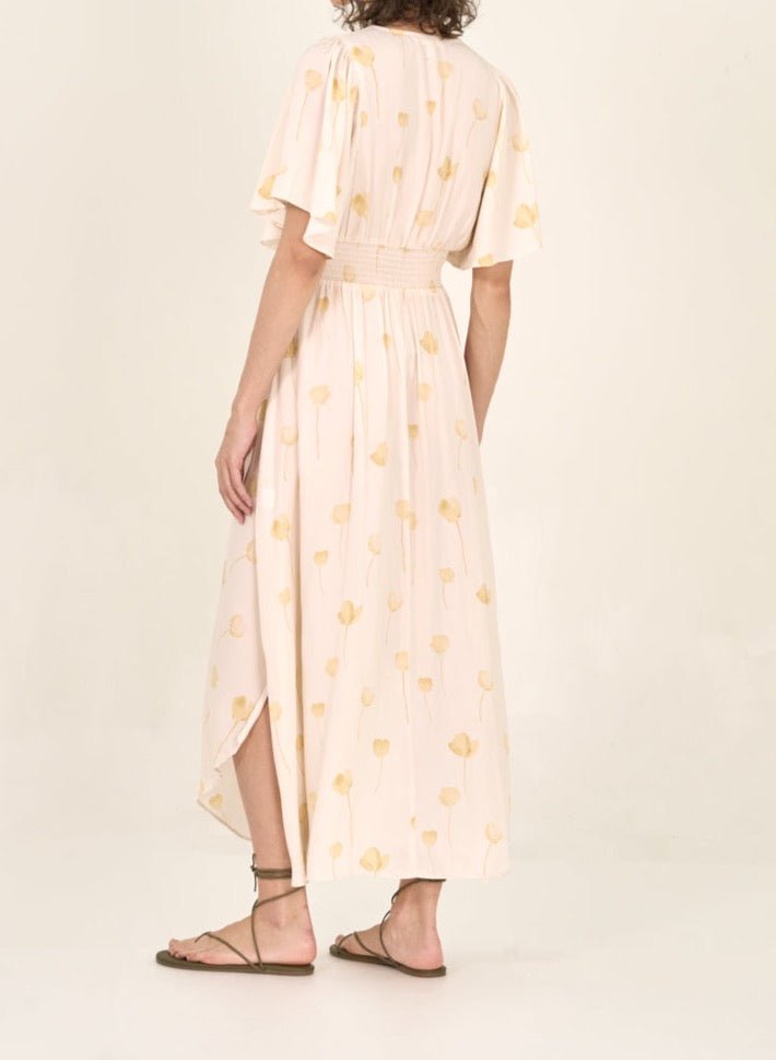 Back view of watercolor floral print maxi dress with flowing hem