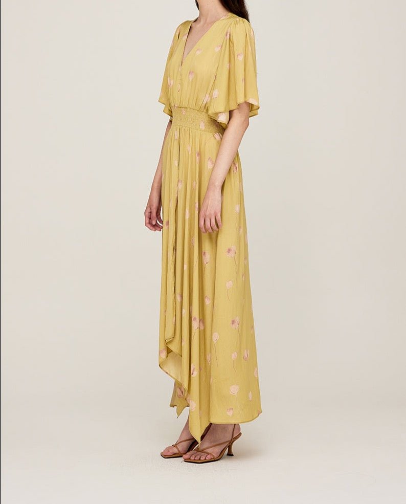 Side view of butter yellow maxi dress with flowing silhouette
