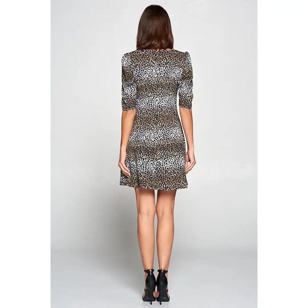 Knee-length animal print dress with puff sleeves and flared silhouette