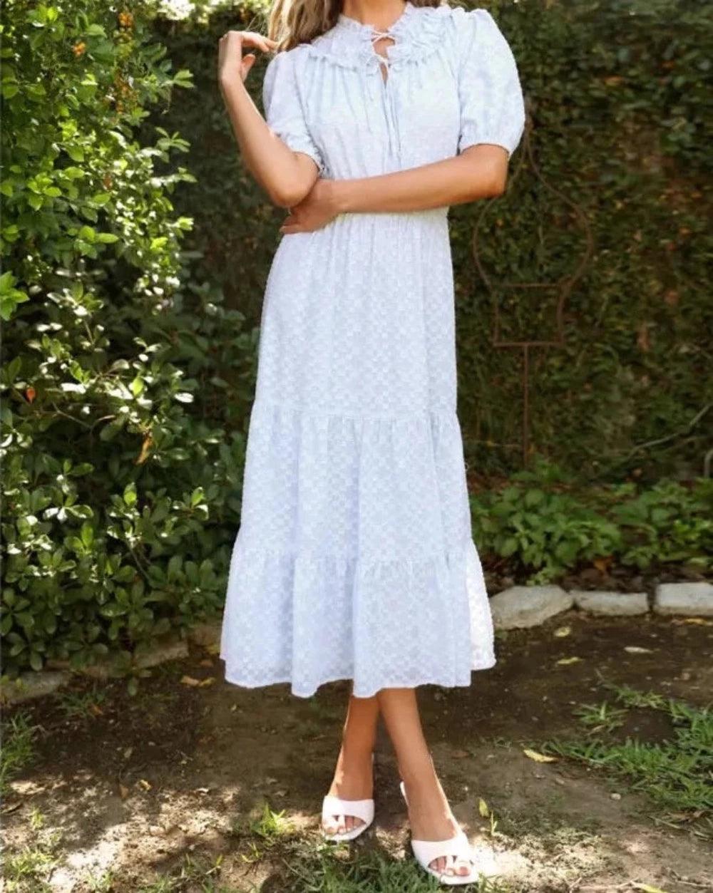 Light blue burnout chiffon midi dress with puff sleeves styled outdoors