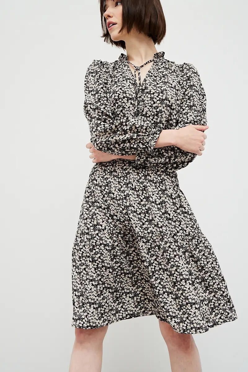 Front view of black ditsy floral dress with puff sleeves