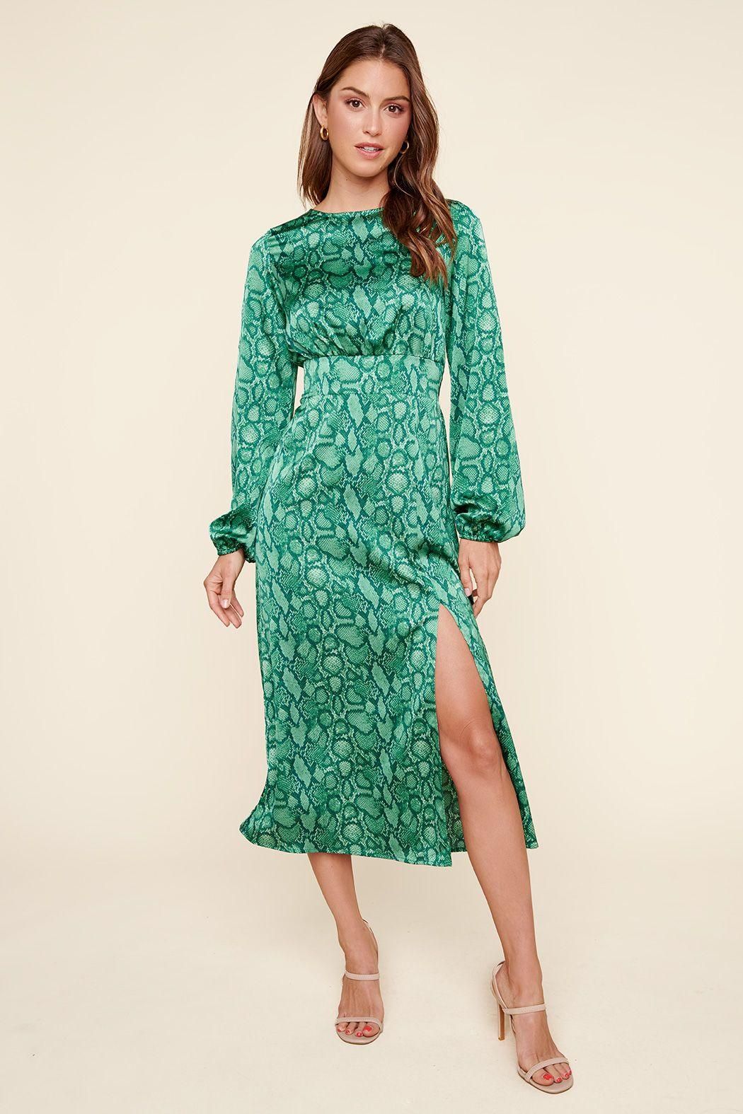 Green snake print midi dress with balloon sleeves and front slit in indoor lifestyle setting