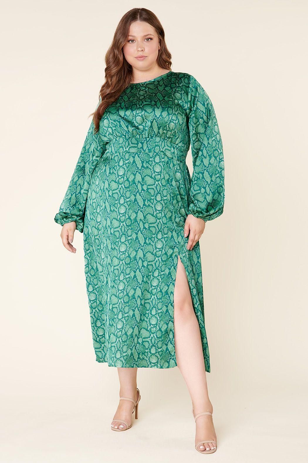Plus size green snake print midi dress with balloon sleeves and front slit in indoor lifestyle setting