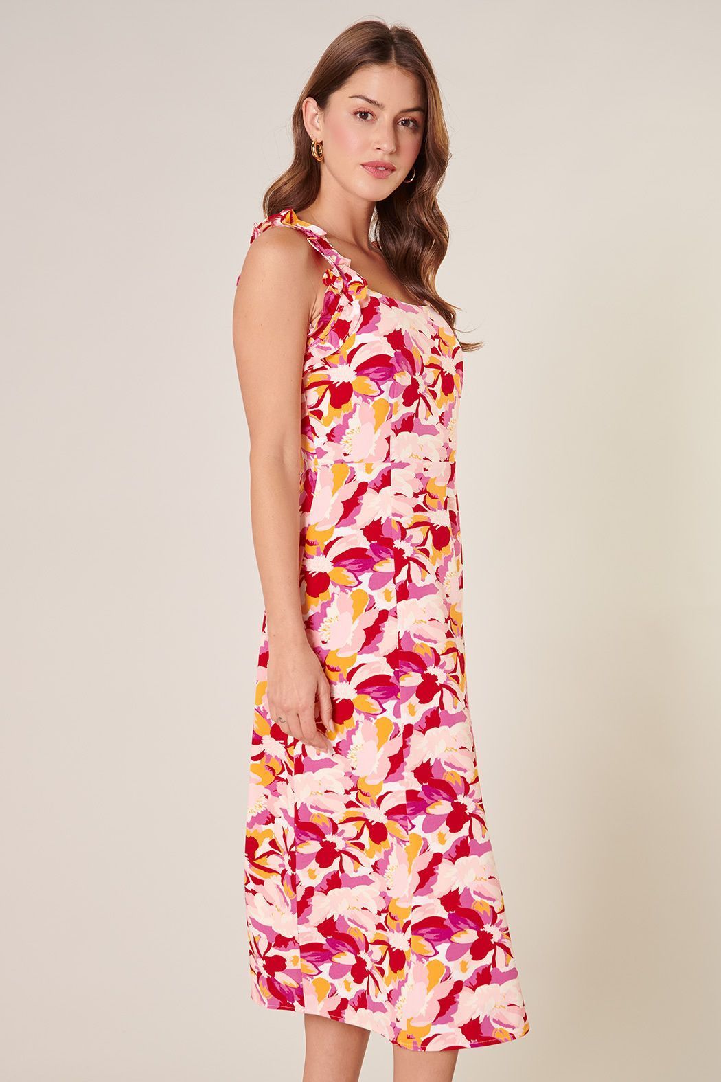 Side view of pink floral sleeveless midi dress with fit-and-flare skirt