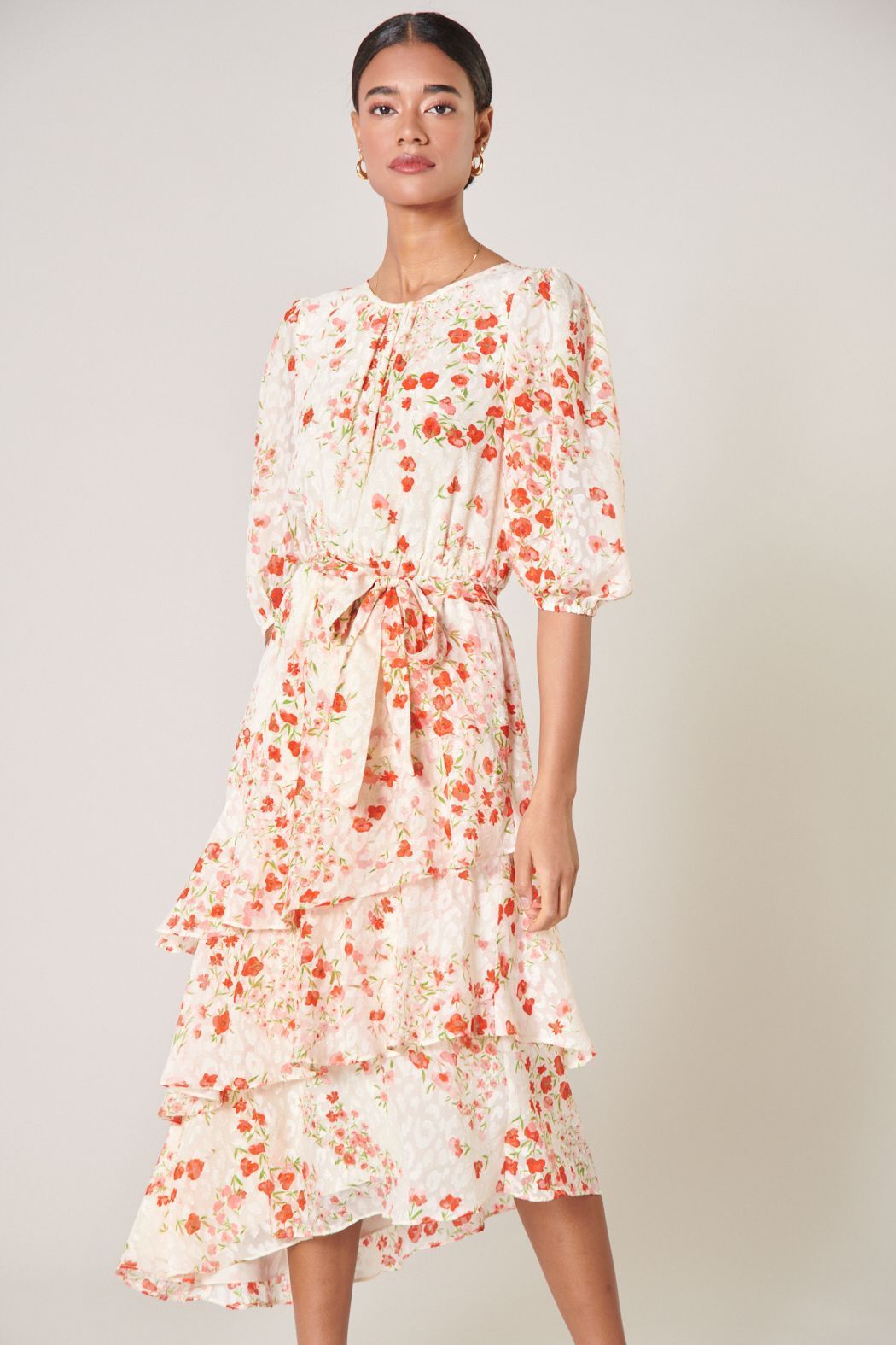 Romantic floral midi dress with elbow-length puff sleeves and cascading ruffle skirt