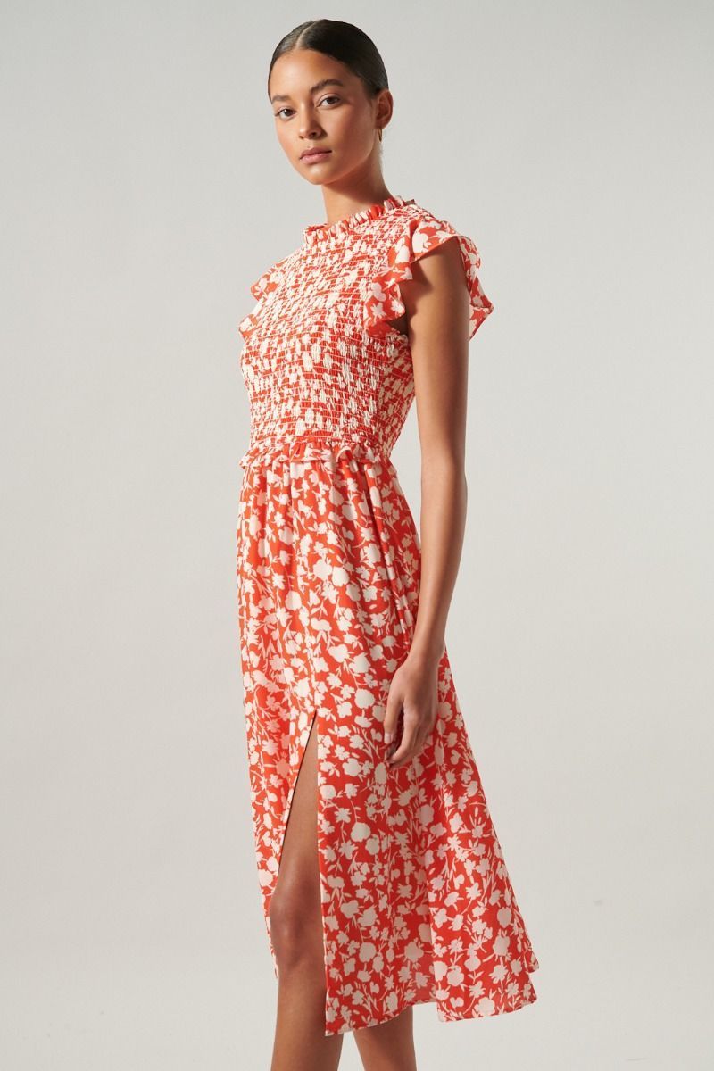 Side view of red and ivory floral midi dress with smocked bodice and ruffle cap sleeves