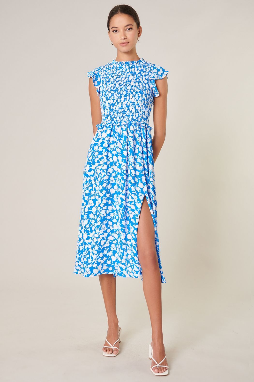 Blue and ivory print midi dress with ruffle sleeves and feminine flowing silhouette