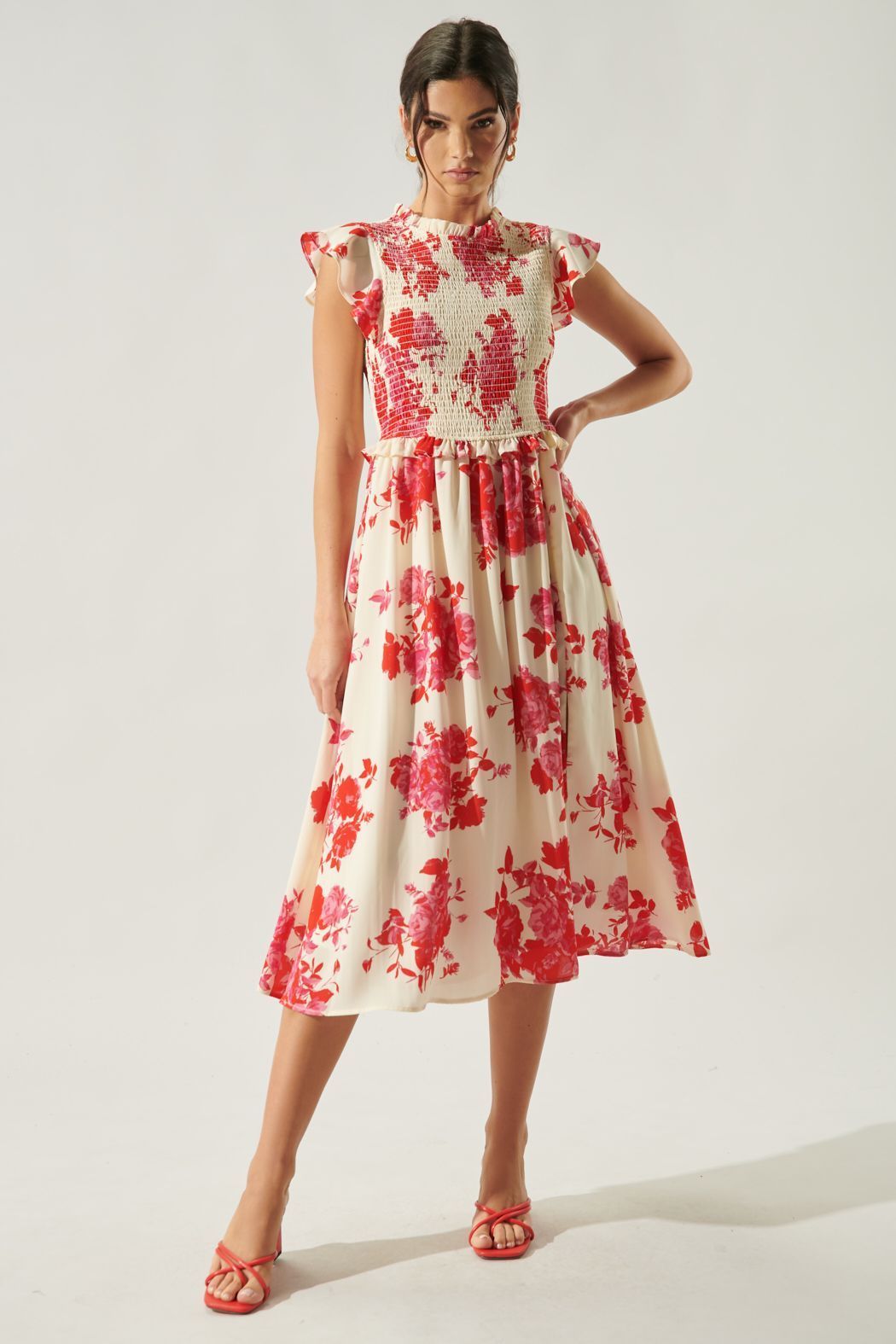 Floral smocked midi dress with ruffle neckline and feminine flowing skirt