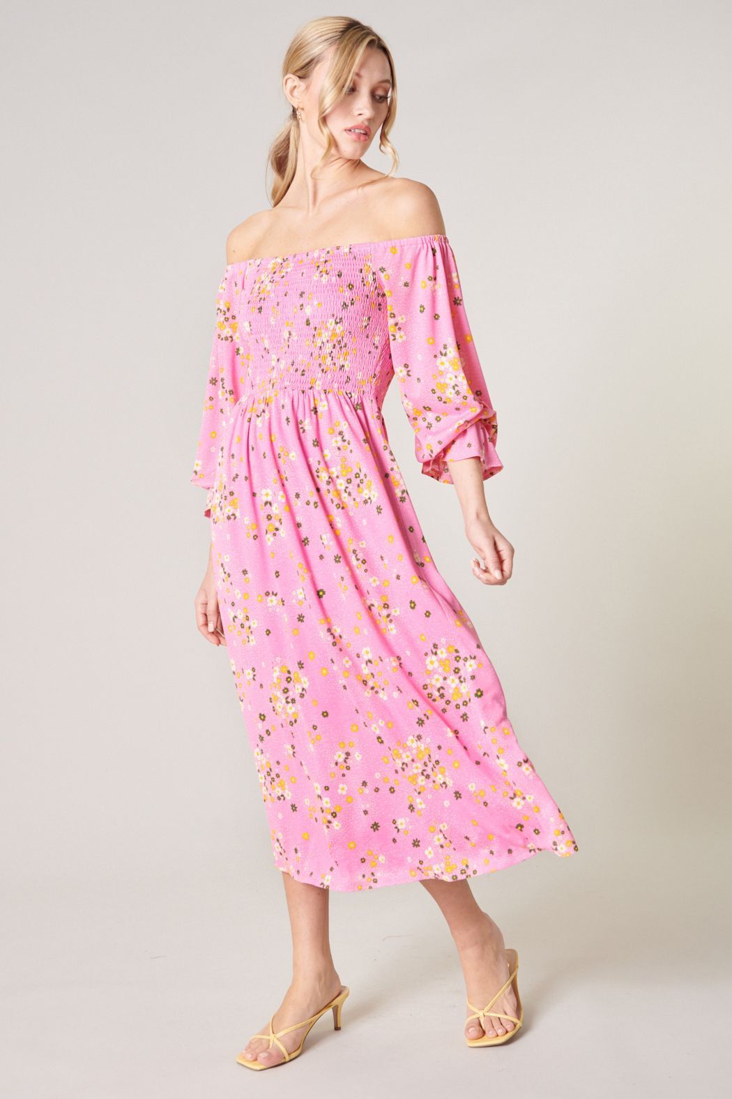 Side view of pink floral midi dress with smocked bodice and long sleeves