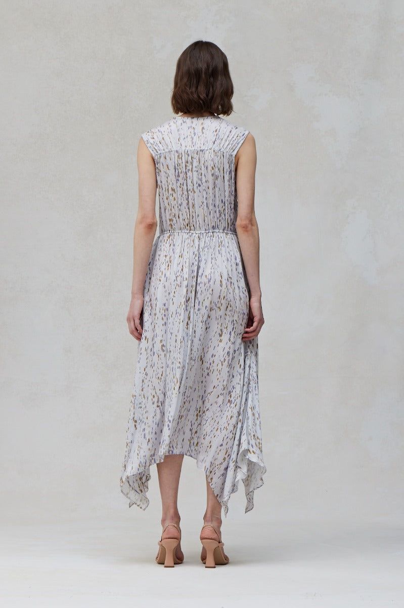 Back view of Blue Dusk sleeveless midi dress with soft abstract print and flowing handkerchief hem